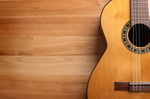 Acoustic guitar with wood background