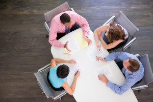 Four businesspeople at boardroom table