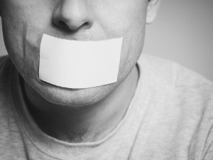 Caucasian man with duct tape on mouth, white . Conceptual image.