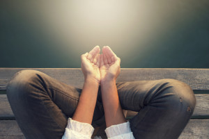 calm woman meditating reciving power by light