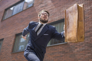 young businessman running in a city street