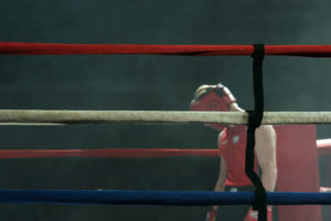 Defeated boxer hangs his head after the fight